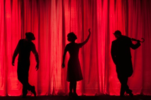 Three people dancing on stage
